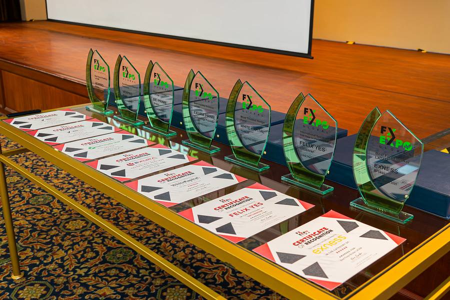 Trophées et certificats alignés sur une table avant une cérémonie de remise des prix